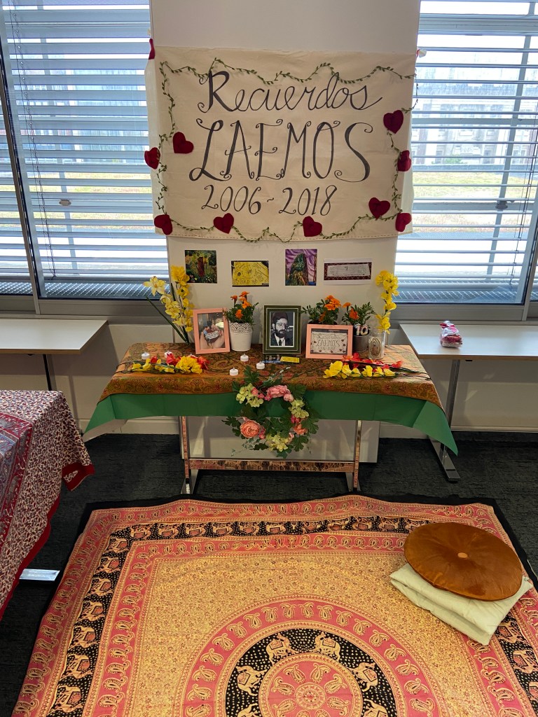 A table decorated with pictures and flowers to honour the LAEMOS Conference and its founder, the late Professor Eduardo Ibarra Colado.